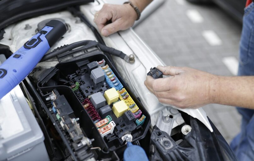 a man is working on a car's engine