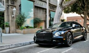 a black car parked on the side of the road