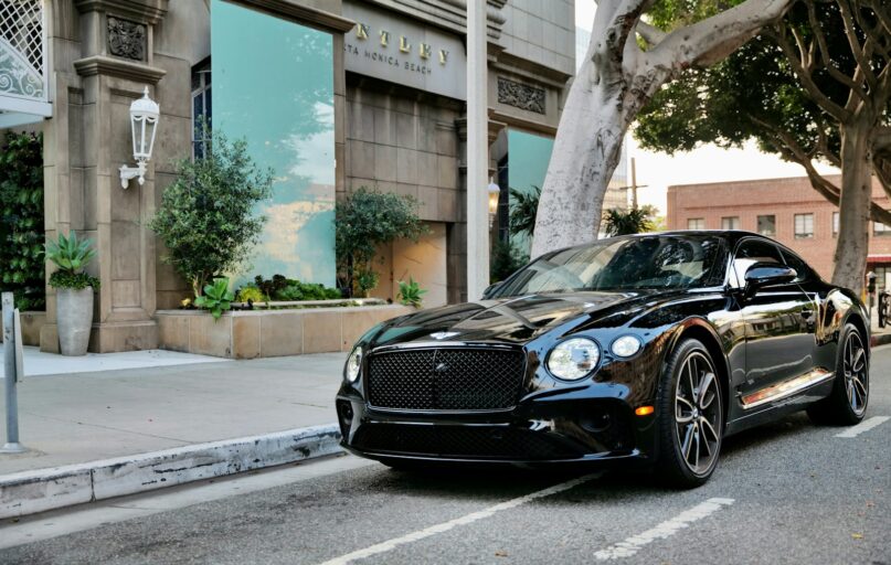 a black car parked on the side of the road