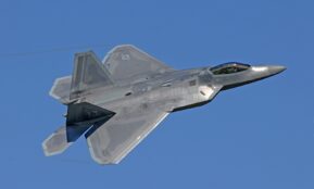 flying gray jet plane