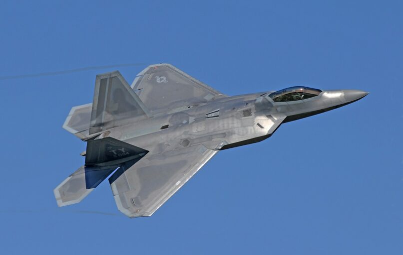 flying gray jet plane