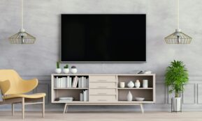 a room with a tv and shelves