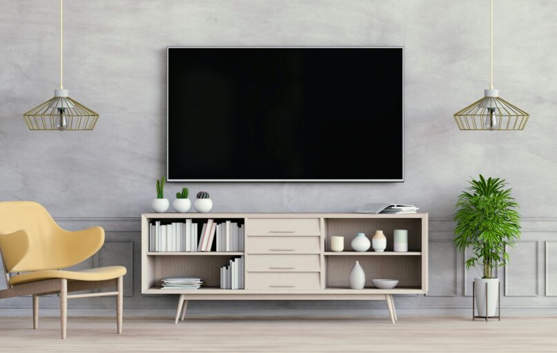 a room with a tv and shelves