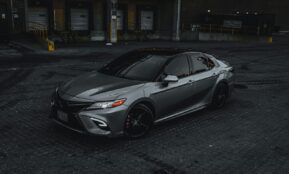 silver sedan parked on road during daytime