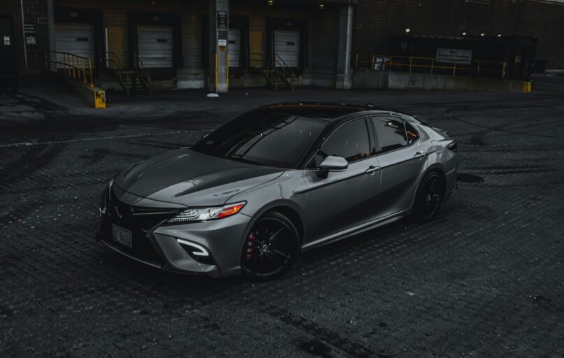 silver sedan parked on road during daytime