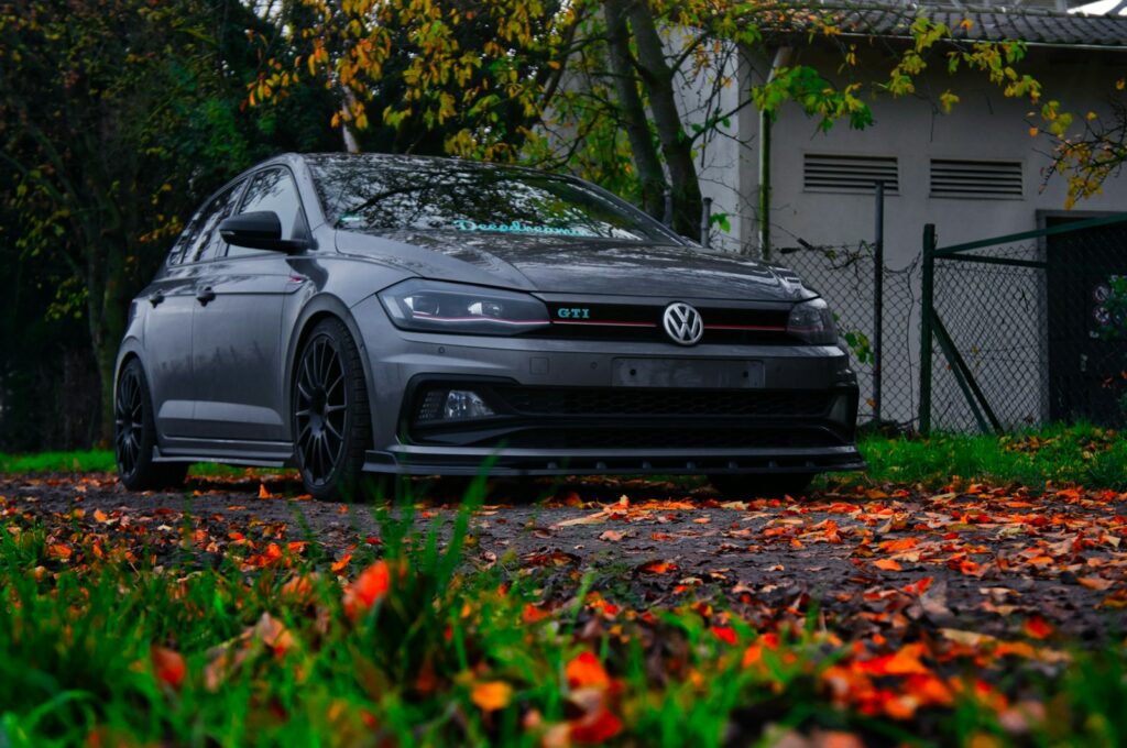 a gray car parked in front of a house