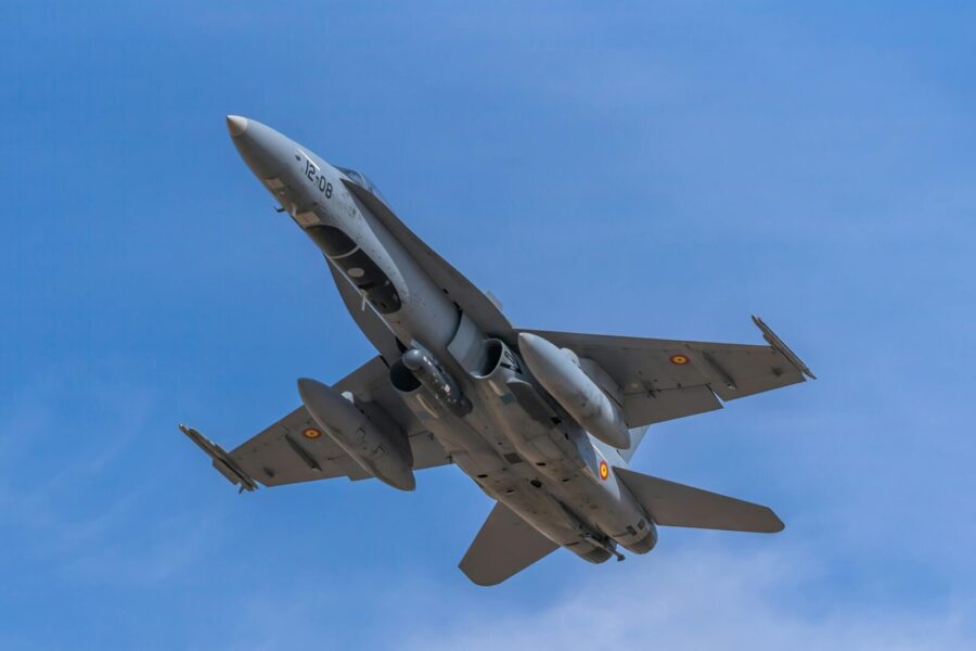 Spanish Air Force F-18 fighter jet soaring through clear blue sky over Albacete, Spain.